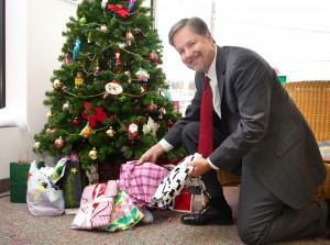 Don Anderson, owner of the Cruise Store in East Longmeadow, places pajamas under the tree at his store.  Additional Pajama Project collection locations include the St. Francis Chapel in Springfield and Tower Square’s City Walk Café on Wednesdays in December from 12pm-1:30pm.